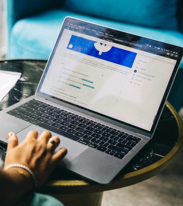 pexels-photo-6751286-6751286 Close-up view of a hand typing on a laptop, symbolizing modern remote work setup.